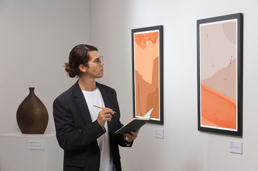 Young man going to art gallery and taking notes